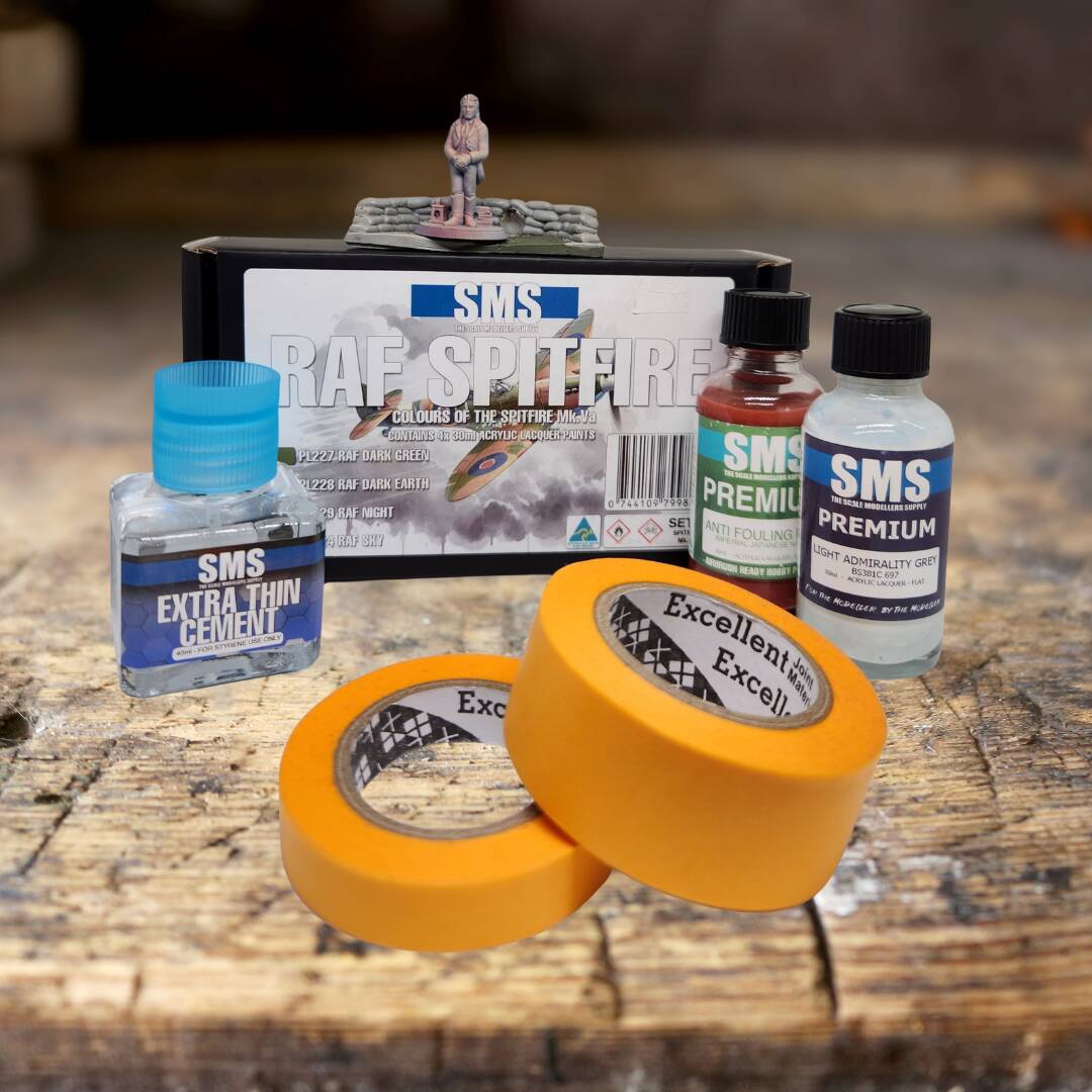 Hobby collection craft supplies including model paints, masking tape, and cement glue for scale modelling.